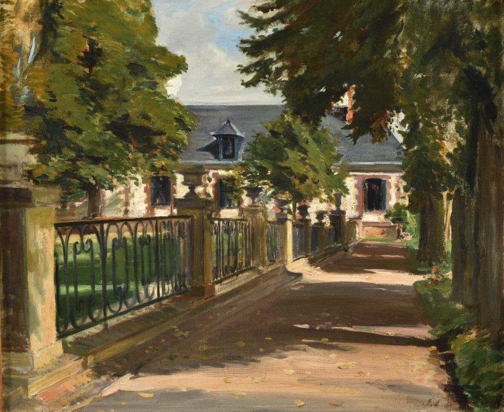 View of a lively shaded driveway of a house